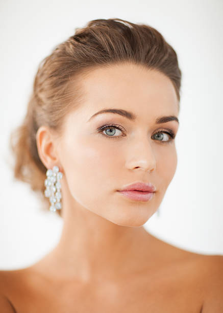 istock woman wearing shiny diamond earrings 178770661