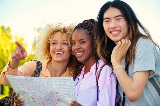 istock Three multiracial friends sightseeing with a local map in Madrid, Spain. 1787714936