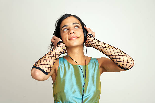 Girl with eyes closed listening to music on headphones stock photo