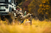 Hunter Seating Next to His All Wheel Drive Vehicle and Drinking Coffee