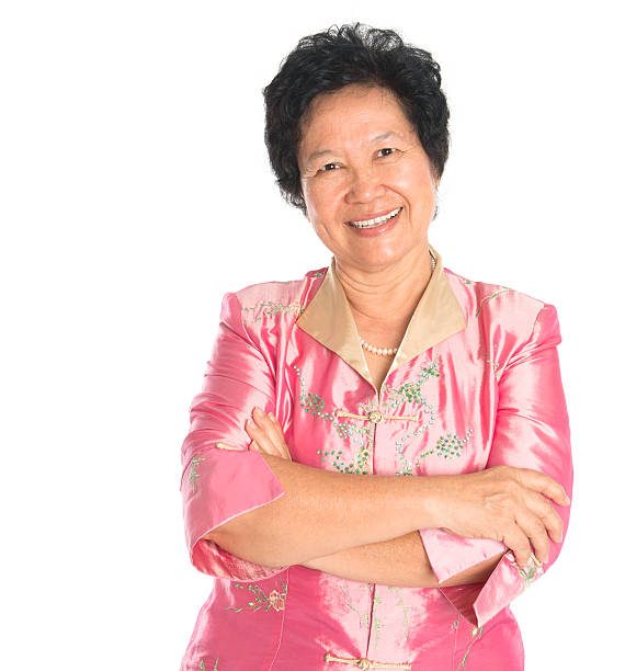 Asian senior woman. Happy smiling Asian grandparent standing isolated on white background.
