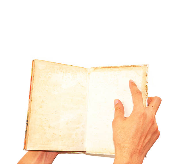 istock Male hand open grunge book isolated on white 178772651