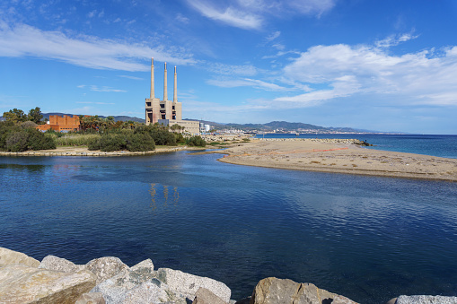 Sant Adriá, Central Thermal Station of Fecsa in Badalona, Barcelona, Spain. Abandoned boiler room with three chimneys surrounded by nature and Besos river.