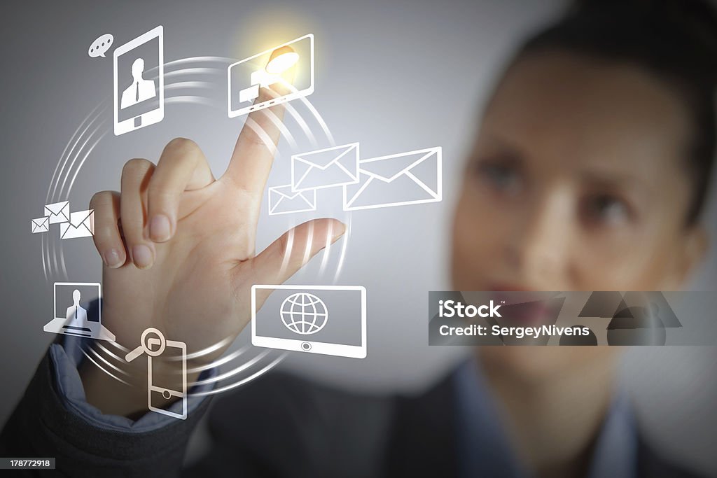 Female businesswoman using touch screen Business person pushing symbols on a touch screen interface Backgrounds Stock Photo