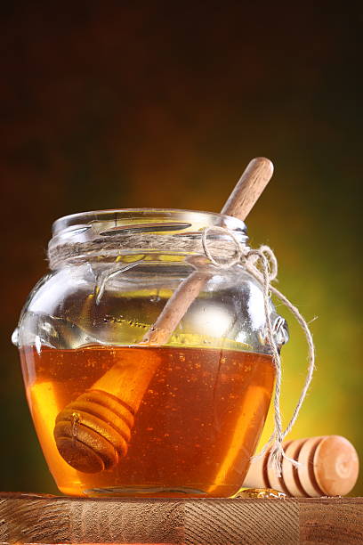 istock Sweet honey pouring from drizzler into the pot. 178773094