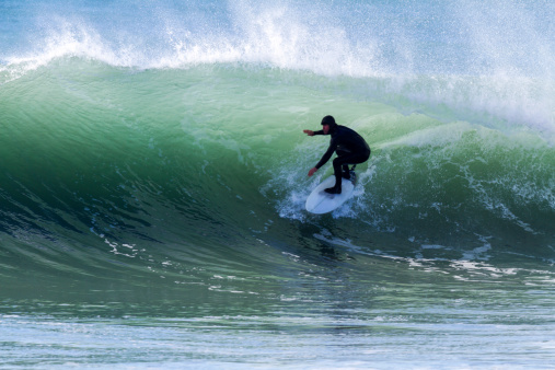 Solo surfer enjoying a fantastic morning of cold water winter surf, Quality waves. What every surfer dreams of. Location Kahutara, Kaikoura, New Zealand