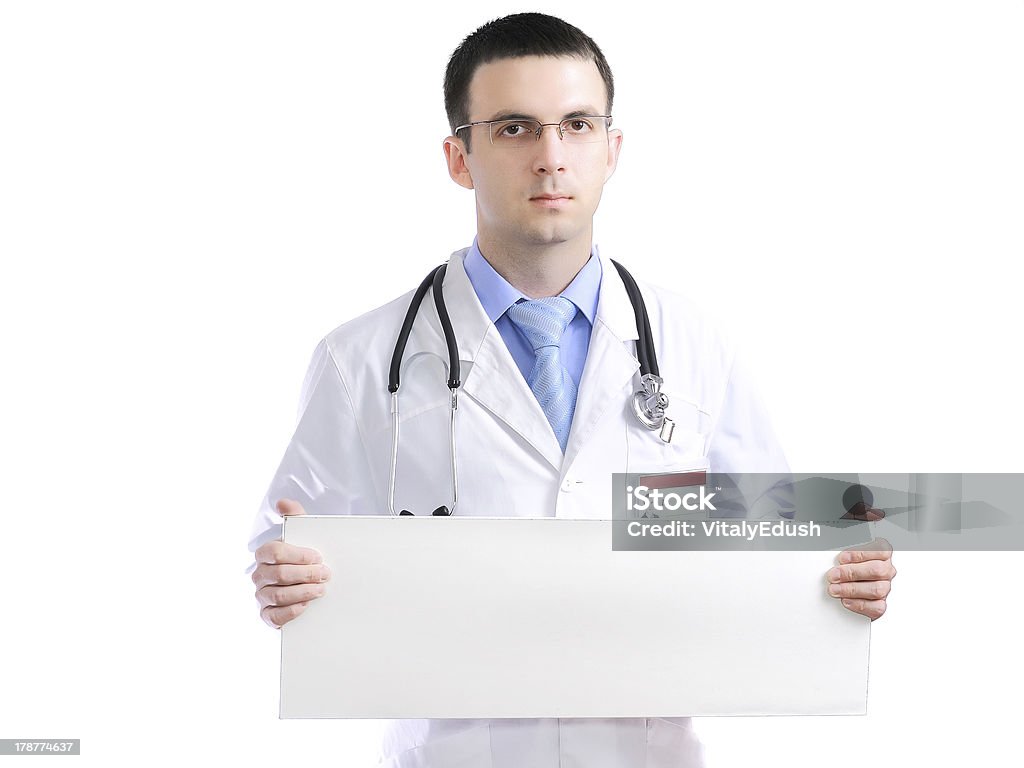 Médico con cartel en blanco. Aislado - Foto de stock de Abrigo libre de derechos