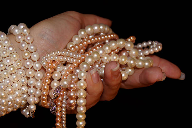 istock Fistfull of pearls 178776283