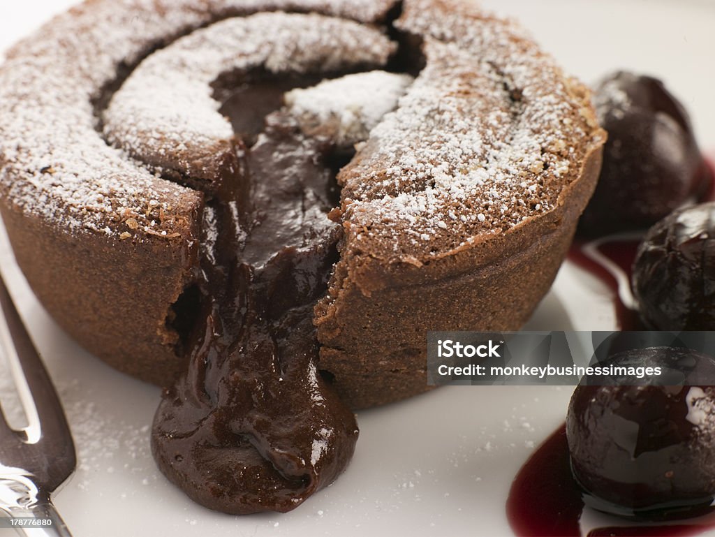 Hot Chocolate Fondant Pudding with Black Cherry Syrup Studio Shot of Hot Chocolate Fondant Pudding with Black Cherry Syrup Cherry Stock Photo