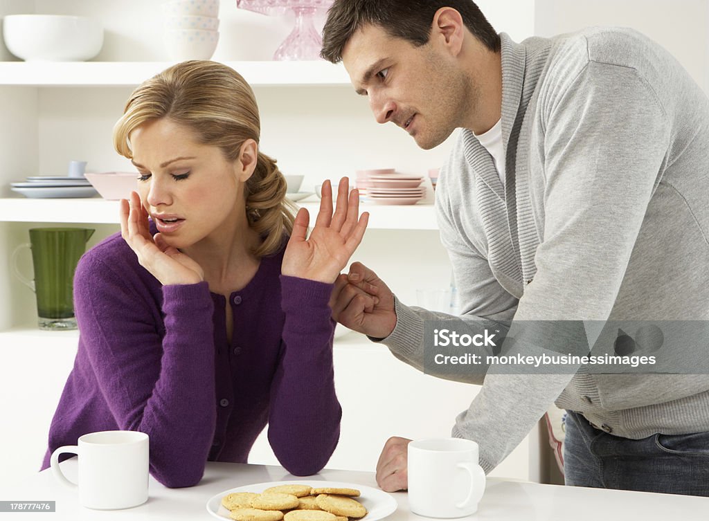 Couple Having Argument At Home Couple Having Argument At Home In Kitchen Having Relationship Difficulties 30-39 Years Stock Photo