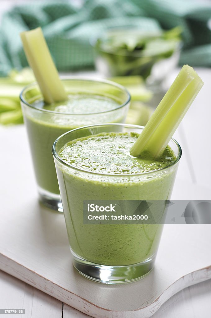 Green vegetable smoothie Green vegetable smoothie with celery and spinach on wooden background Celery Stock Photo