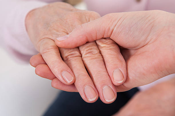 istock Young Woman Holding Senior Woman's Hand 178778842