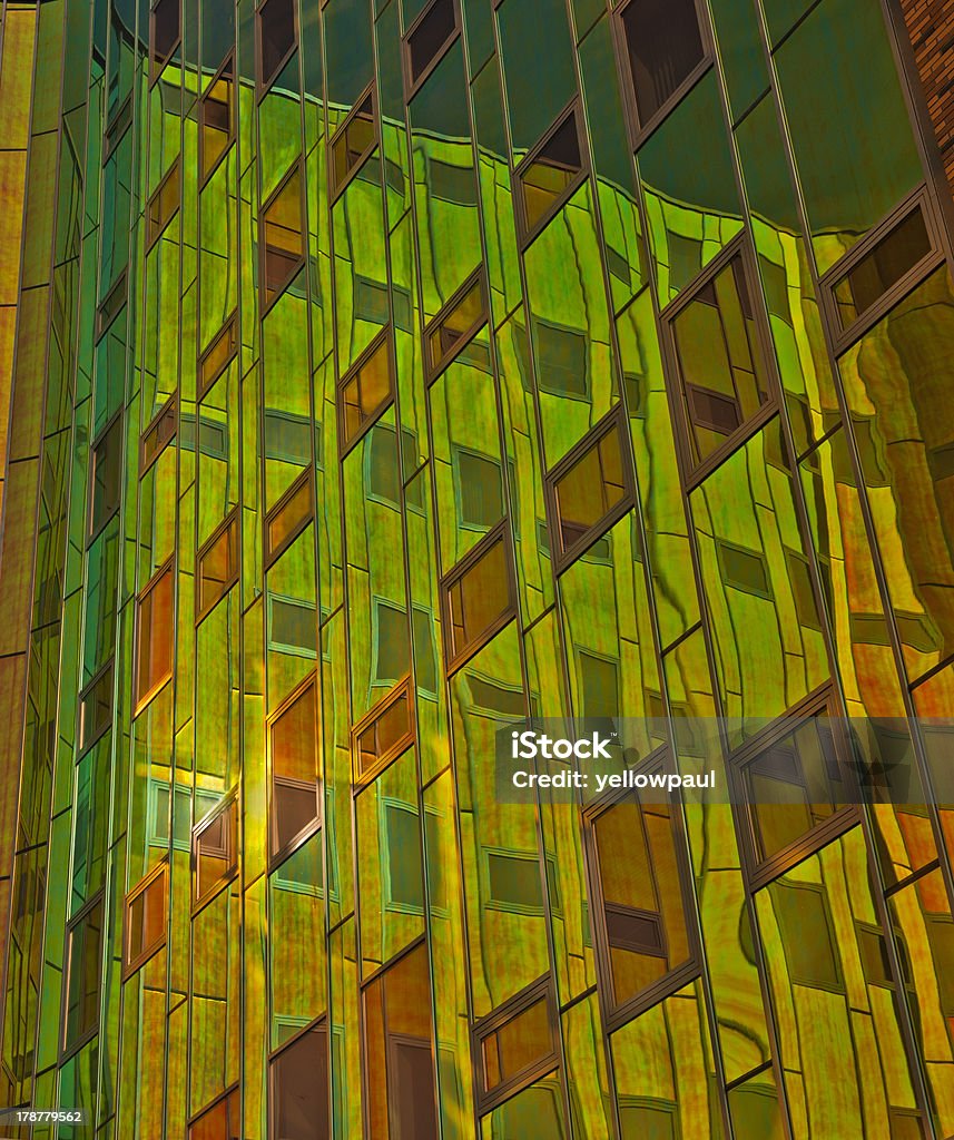 Office building with reflecting windows "Office building with green, yellow  and orange reflections in windows" Architecture Stock Photo