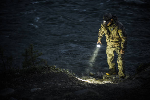 istock Missing Person Search Staff Member Next to River at Night 1787803017