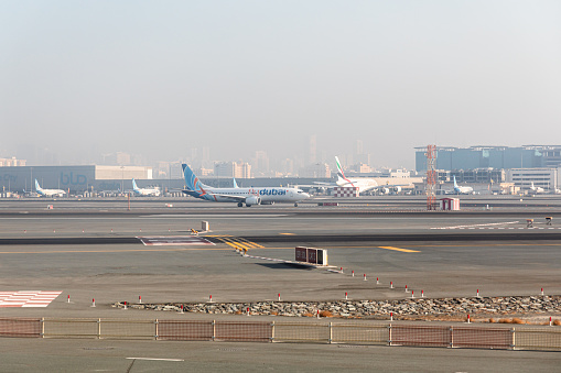 Dubai, United Arab Emirates - October 12, 2023: Emirates and Fly Dubai planes in the Dubai International Airport