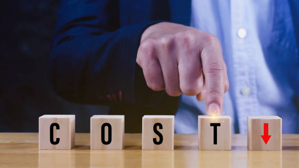 istock Cost reduction concept, Lean manufacturing management, Decreasing company expense to maximize profits, Hand arranging wooden cube with text cost with red down arrows, Business survival and improvement. 1787822626