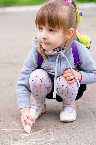 istock girl drawing with chalk 178783728