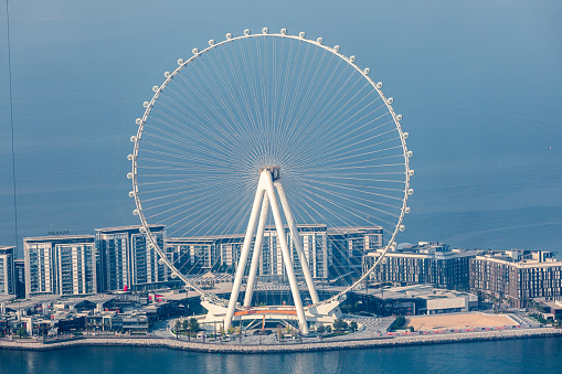 Dubai, United Arab Emirates - June 21, 2023: Bluewaters island in Dubai with Ain Dubai Ferris wheel seen from JBR beach in Marina area. The tallest giant observation wheel ever built