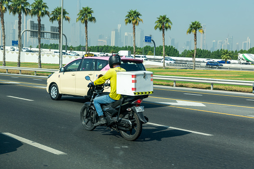 Dubai, United Arab Emirates - June 21, 2023: Dubai Food Delivery Motorcyclist Driver