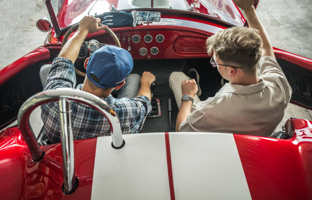Caucasian Collectible Vehicles Owner Explaining His Car Mechanic Some Potential Issues