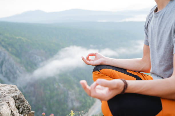 istock A guy sits on a mountain in a meditation pose, hands folded into chinmudra, yoga practice in nature, concentration of inner strength, om shanti, zen, body part 1787881077