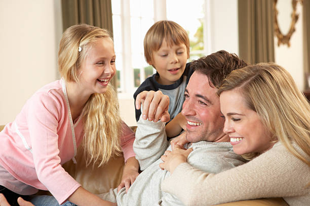 istock Happy young family playing together on sofa 178788504