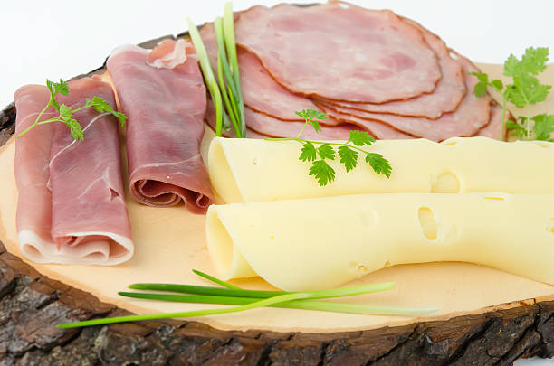 Appetizer of prosciutto on the wood board