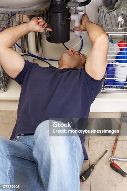 Plumber Working On Sink In Kitchen Stock Photo - Download Image Now - Repairing, Sink, Waste Management