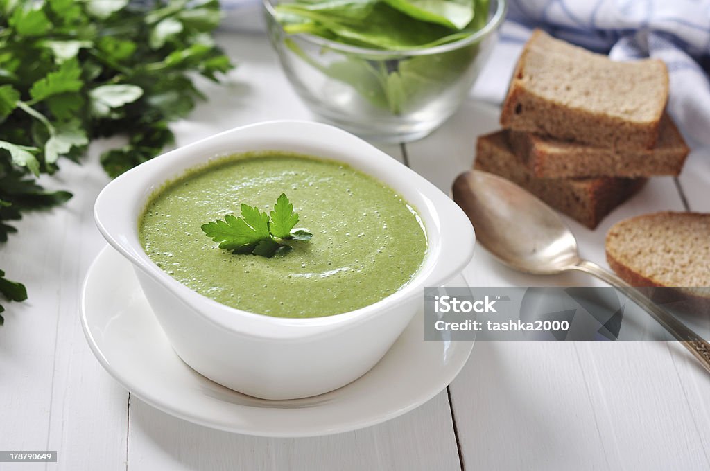 spinach soup spinach soup in a bowl on a wooden background Bowl Stock Photo