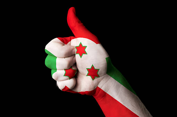 Hand with thumb up gesture in colored burundi national flag as symbol of excellence, achievement, good, - for tourism and touristic advertising, positive political, cultural, social management of country