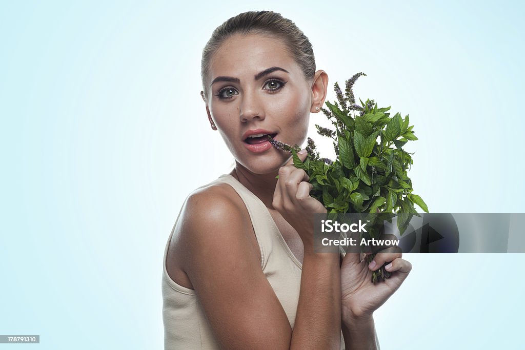 woman with bundle herbs (mint). Concept vegetarian dieting - he Close-up portrait of happy young woman with bundle herbs (mint) in hands on white background. Concept vegetarian dieting - healthy food Adult Stock Photo