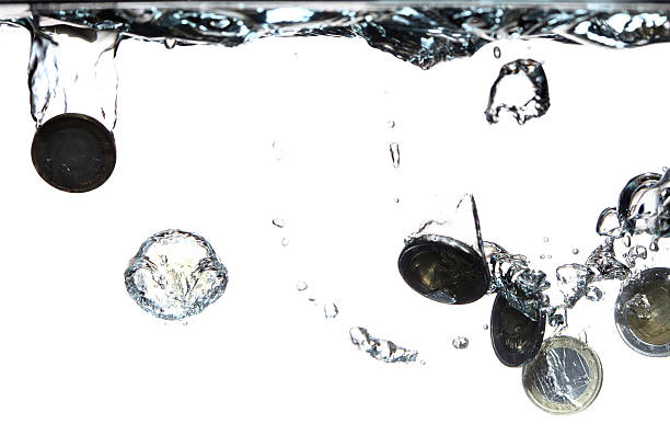 istock Euro coins falling into the clear water 178791509