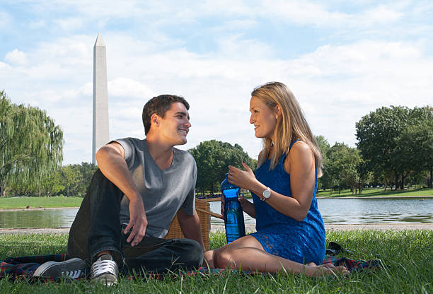 Man and Woman having picnic in park stock photo