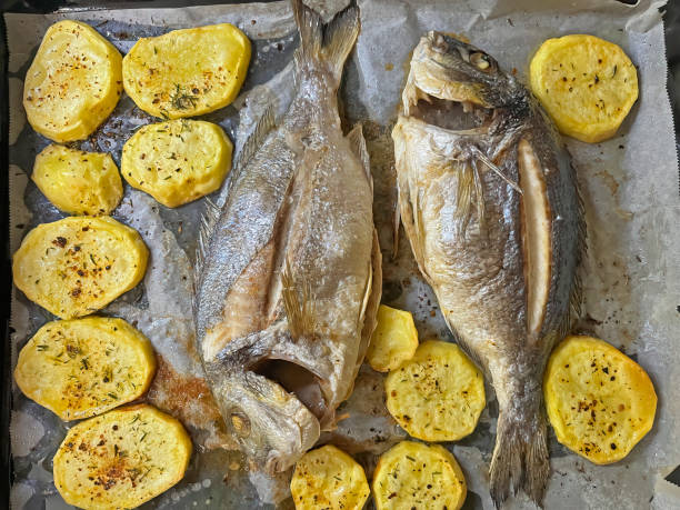 istock Oven-baked fish and potato wedges. Sea bream. 1787924788