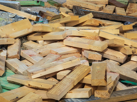 Closeup of a pile of short ends of sawn lumber on the construction site of a single-family house in southwest Florida