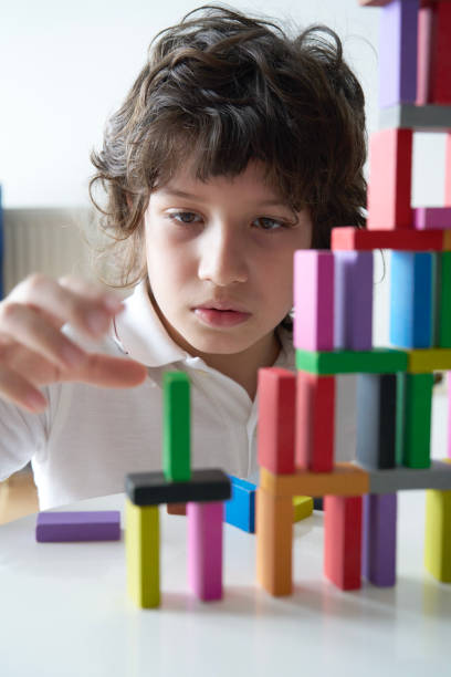 istock Cute Little Boy Playing with wooden block 1787932393