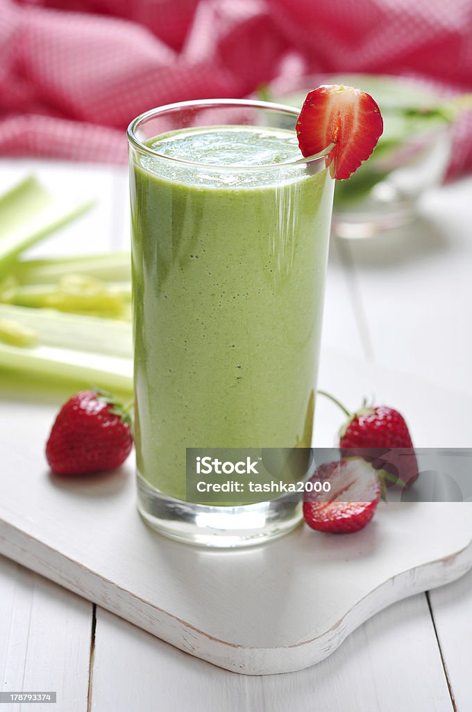vegetable smoothie Green vegetable smoothie with celery and strawberry on wooden background Berry Fruit Stock Photo