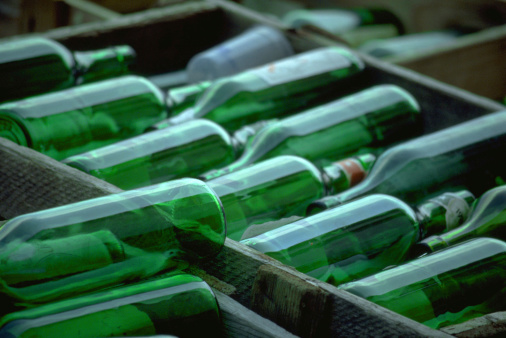 Some cases of green, empty wine bottles