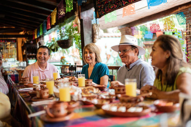 istock Happy senior friends talking at restaurant 1787954779