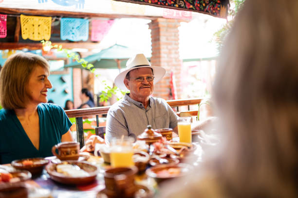 istock Happy senior friends talking at restaurant 1787955867
