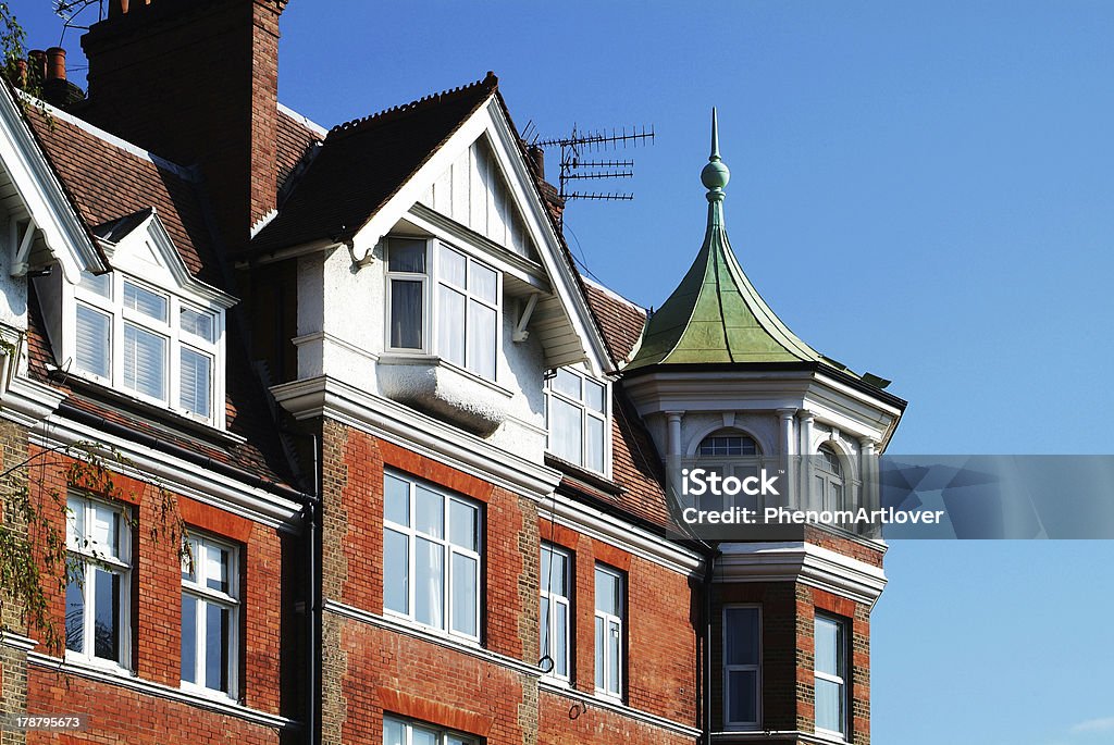 House with green dome photo of a red brick house with a green dome, somewhere in London, UK Architectural Dome Stock Photo