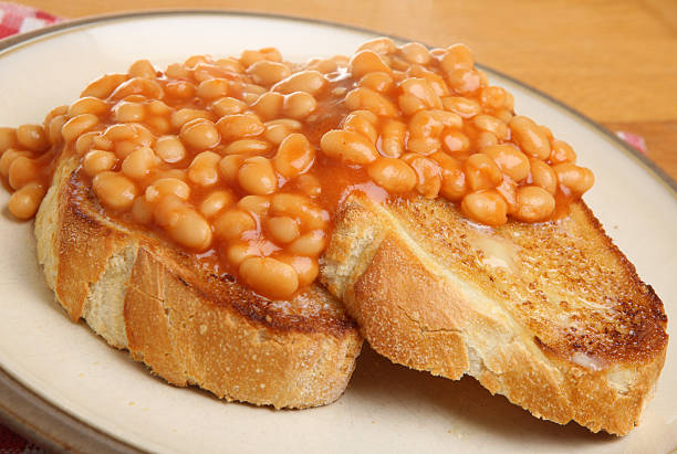 Baked Beans on Toast Beans on toast with visible steam rising baked beans stock pictures, royalty-free photos & images