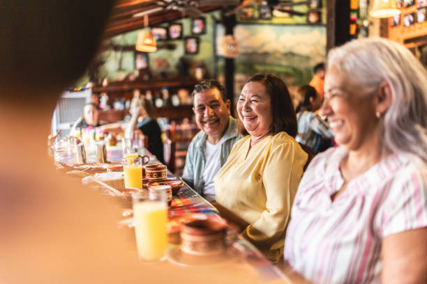 istock Happy senior friends talking and eating at restaurant 1787965697