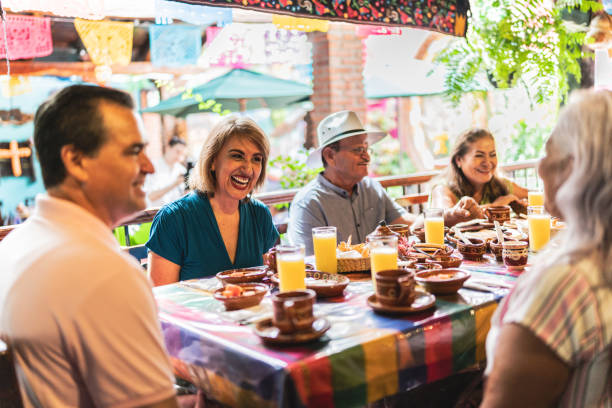 istock Happy senior friends talking and eating at restaurant 1787965715