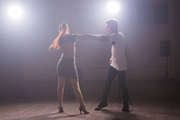 istock Young couple dancing latin dance Bachata, kizomba, merengue, salsa. Two elegance pose in dance class. 1787970901