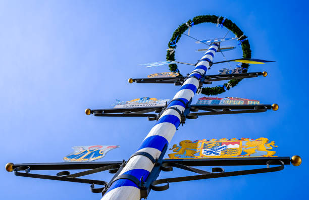 Munich, Germany - September 24: typical wooden bavarian maypole in front of blue sky at the oktoberfest in Munich on September 24, 2023