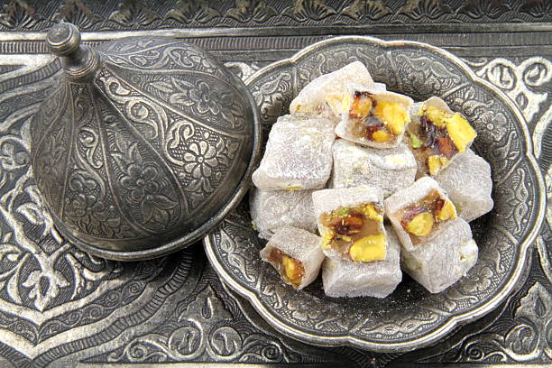istock Turkish delight with  pistachio nuts on carved patterned metal plate. 178798272