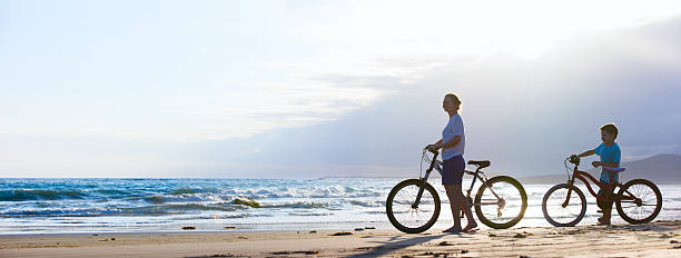 istock Mother and son biking at beach 178799168