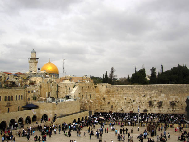 People at the Western Wall (Wailing Wall), some praying, in the back the gold plated Dome of the Rock, Jerusalem old town, Palestine - Israel