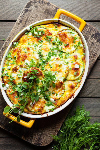 zucchini baked with cheese in a dish stock photo